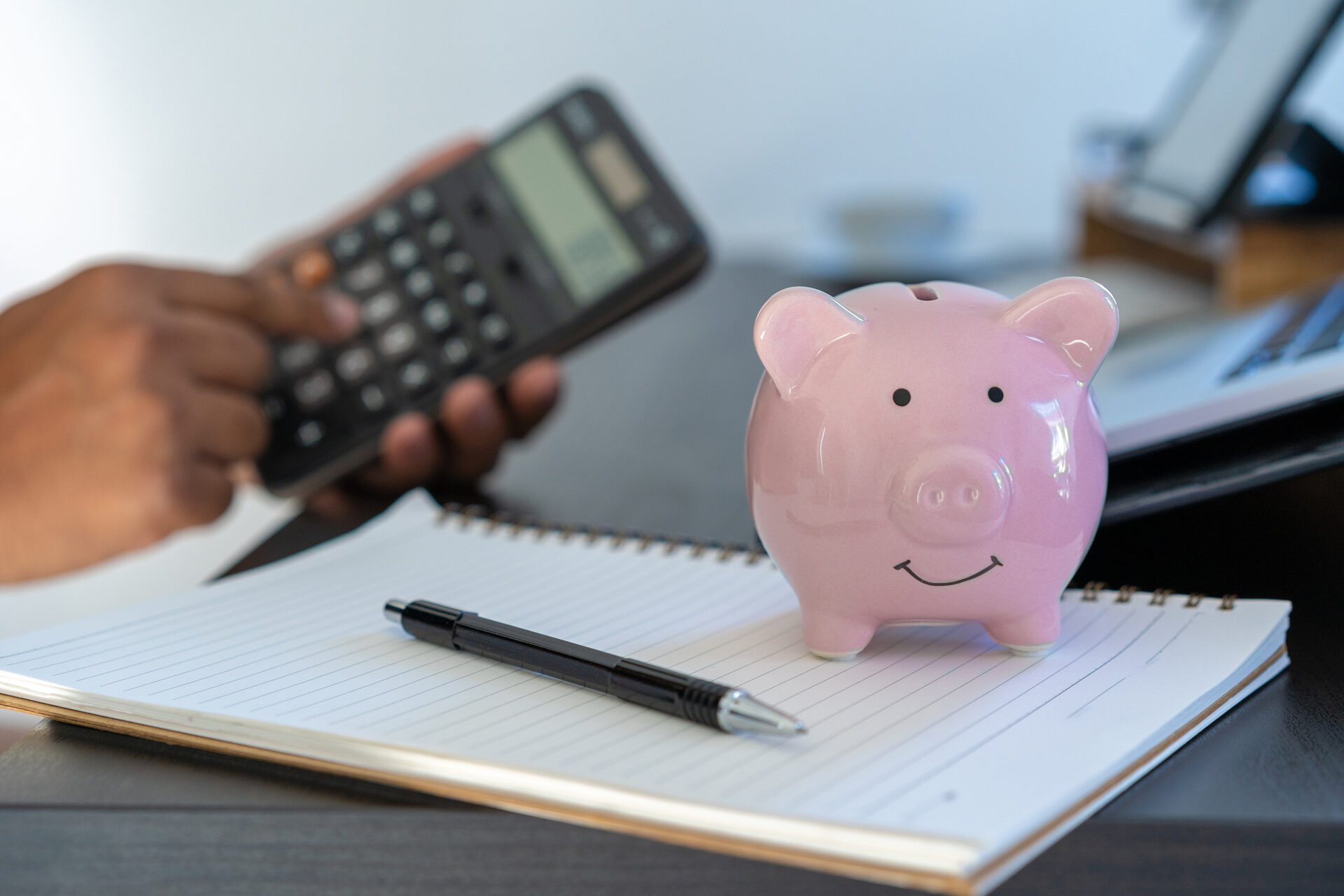 piggybank And Calculator On Desk business document calculator co